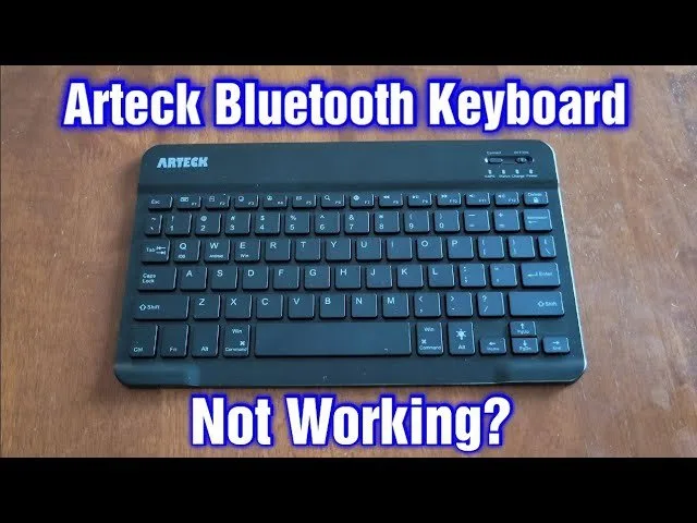 A clean office workspace with a wireless keyboard and coffee on the desk.