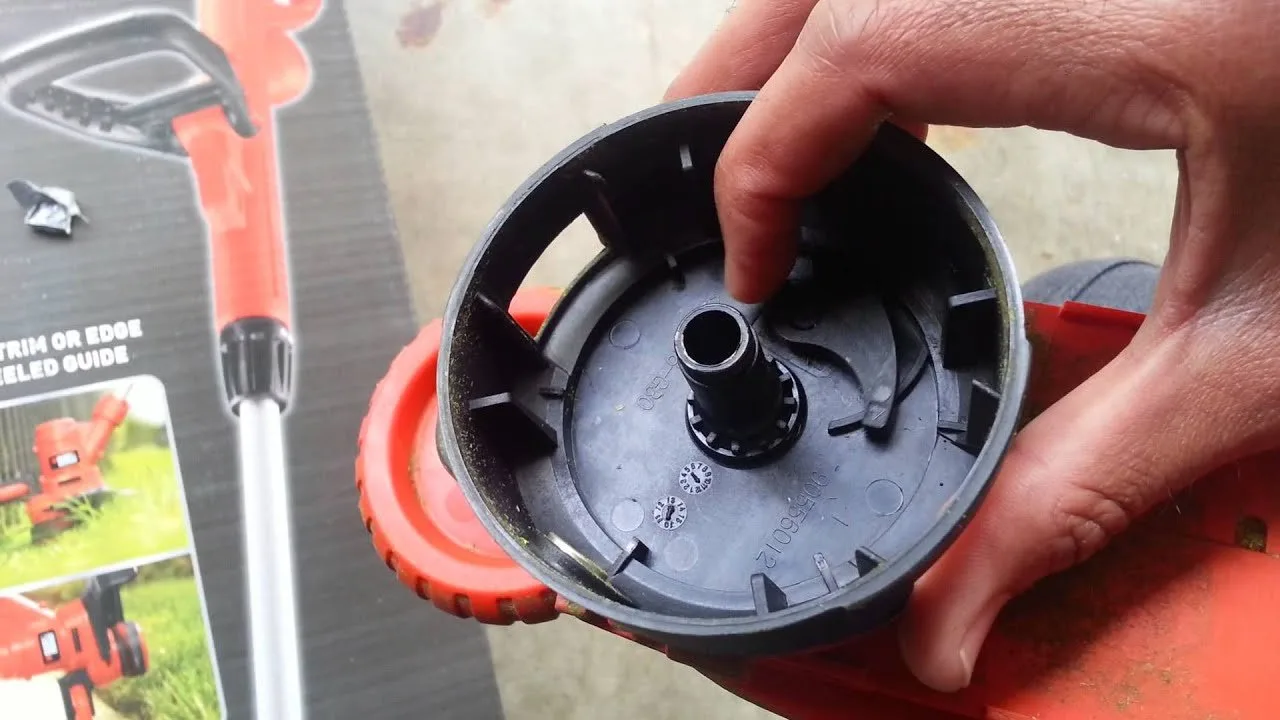An empty and incorrectly wound trimmer spool showing why the automatic feed stopped working.