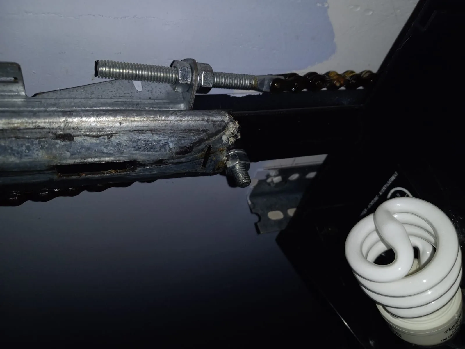Tools for repairing a garage door opener laid out neatly on a workbench.