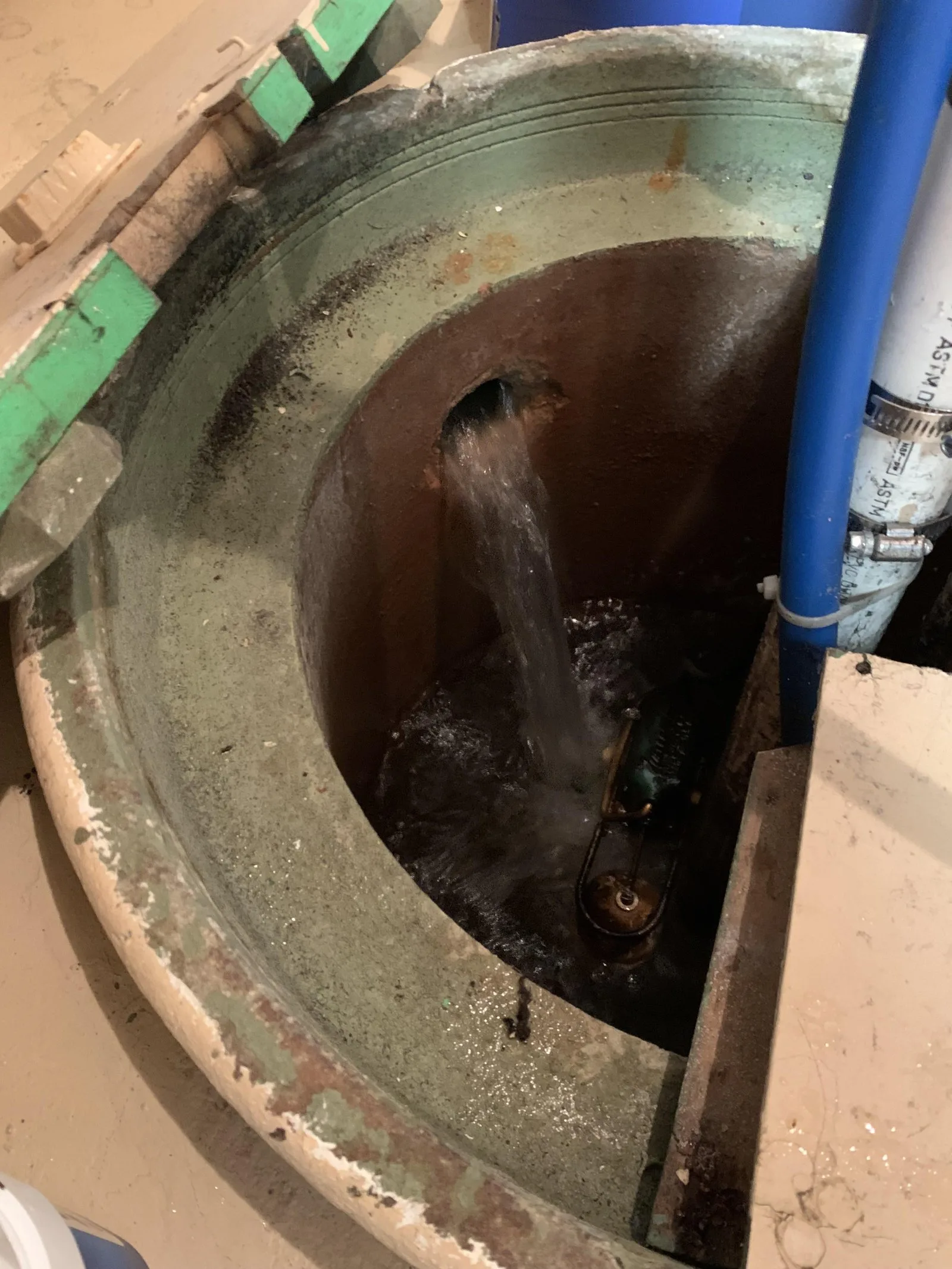 A person adjusting the float switch of a sump pump to prevent cycling issues.