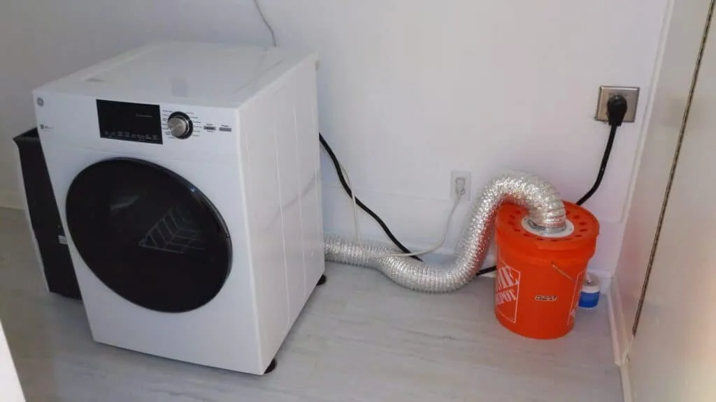 A rigid metal dryer duct properly connected to a home laundry machine.