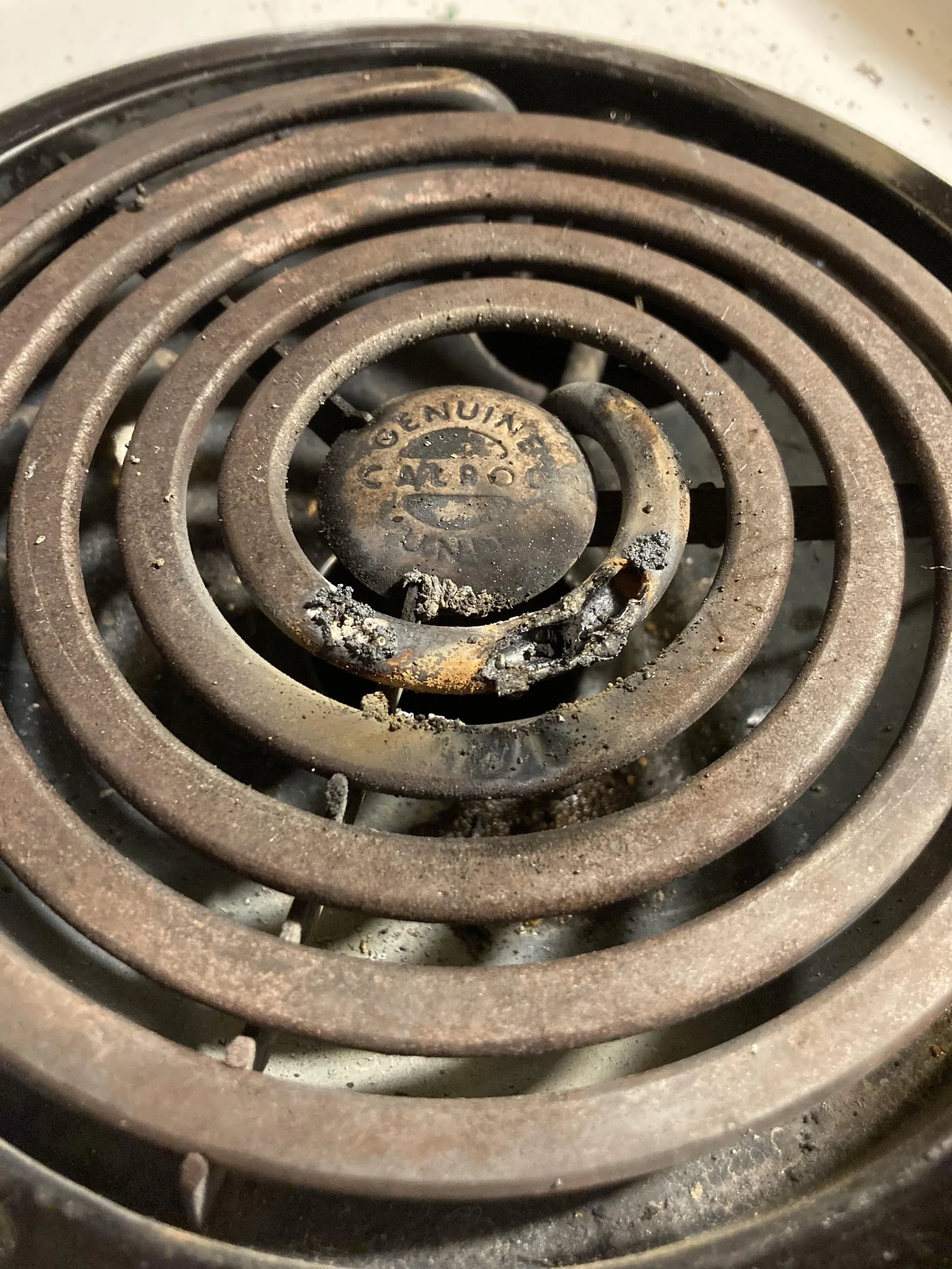 An oven manual placed on the handle of an appliance to help answer repair questions.