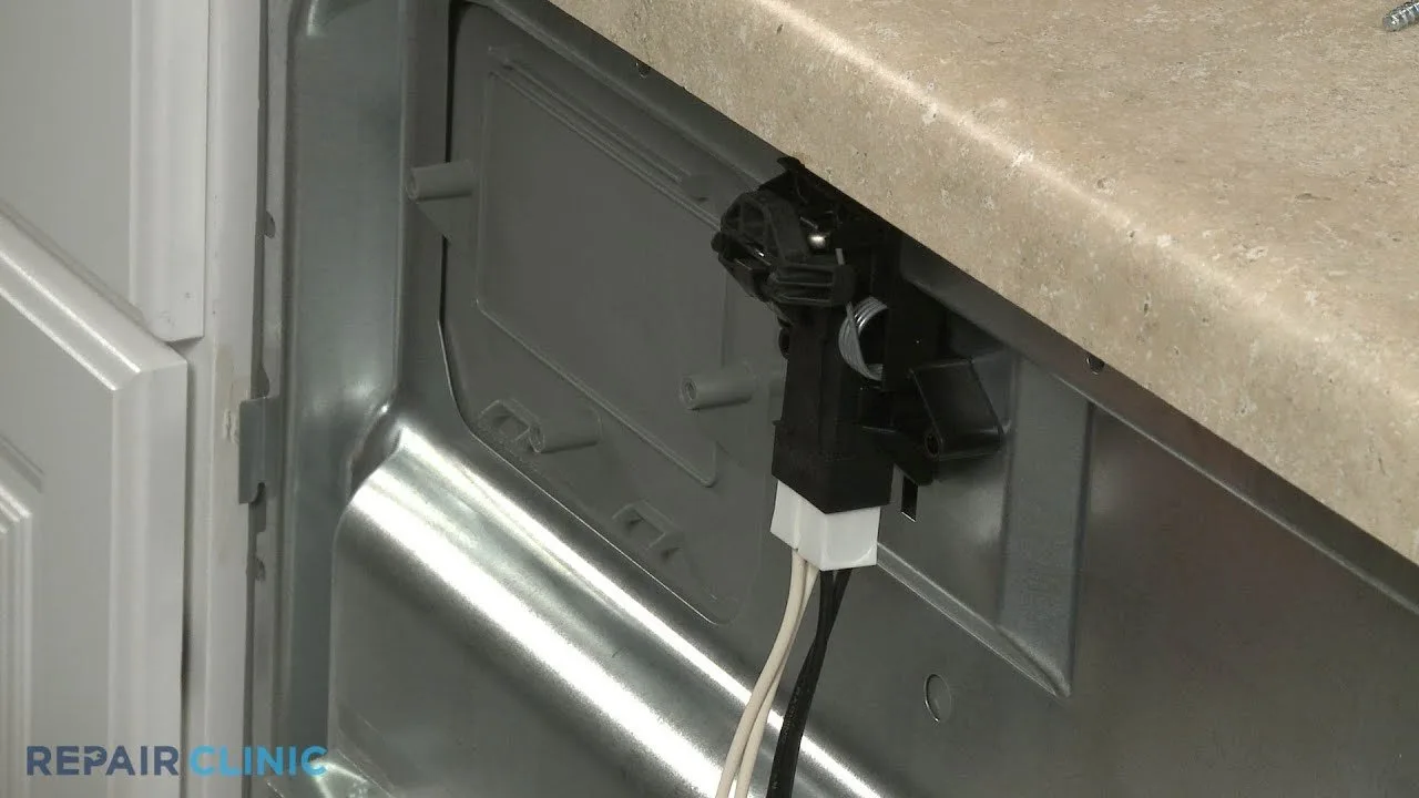 Replacement latch assembly part held near an open dishwasher door for repair.