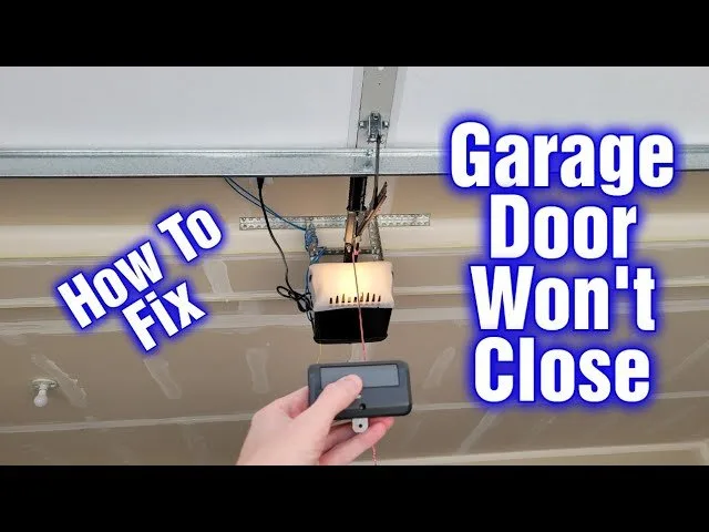 Safety sensors installed at the base of a garage door track for monitoring.