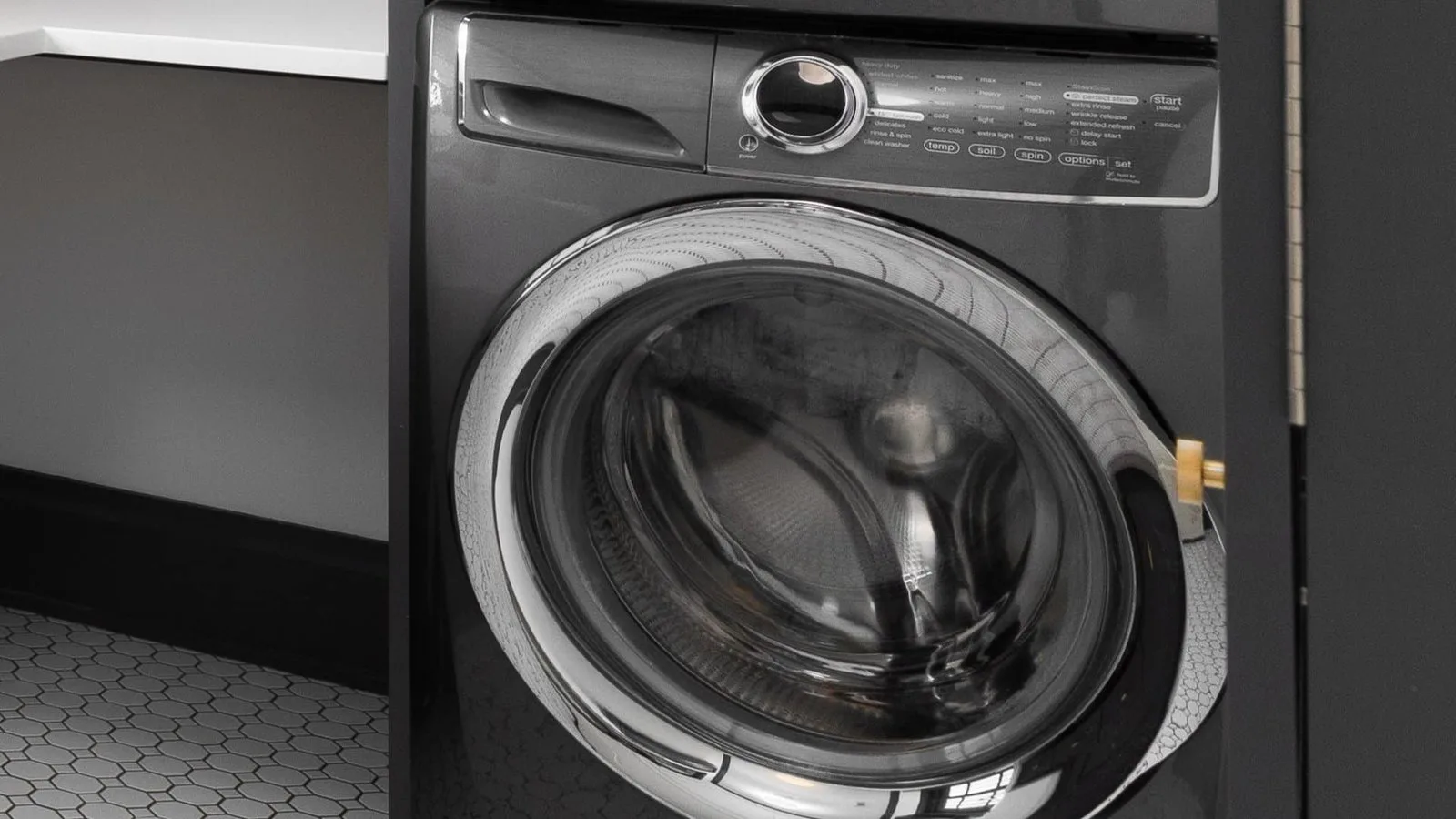 Close up of washing machine water intake hoses connected to wall valves.