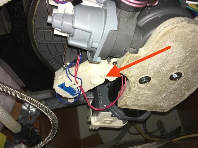 Turning off the water supply valve under the kitchen sink to stop the leak.