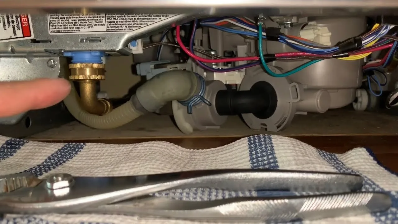 Inspecting and clearing the spray arm nozzles of a dishwasher for blockages.