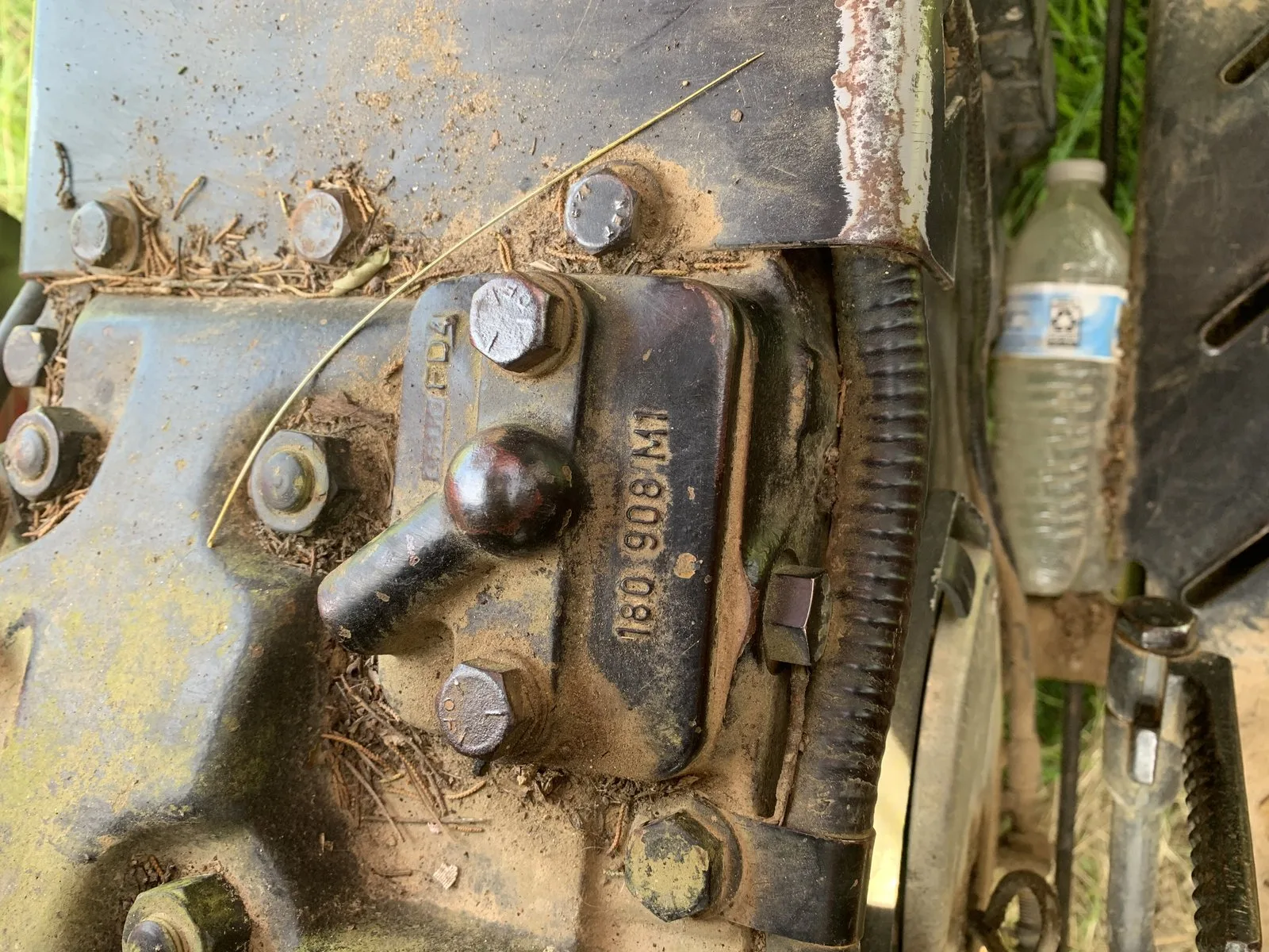 A maintenance manual lying on the fender of a Massey Ferguson 231 tractor.