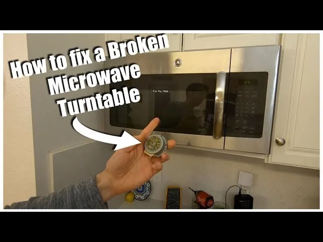 Hands checking a microwave turntable ring and glass tray for common debris.