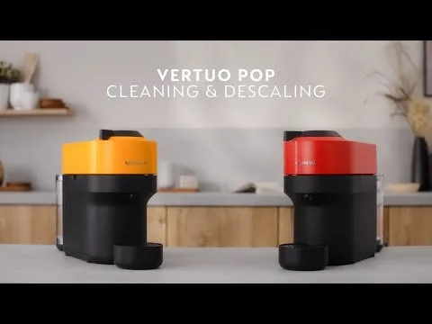 A person pushing the water reservoir into a Nespresso Vertuo coffee machine base.