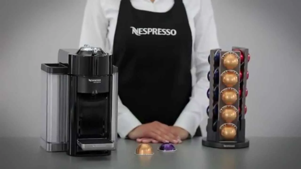 A Nespresso Vertuo machine arranged neatly on a kitchen counter with coffee accessories.