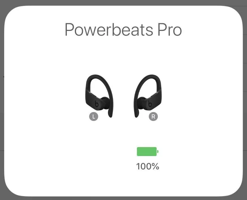 Wireless earbuds and a cleaning cloth arranged neatly on a modern desk.