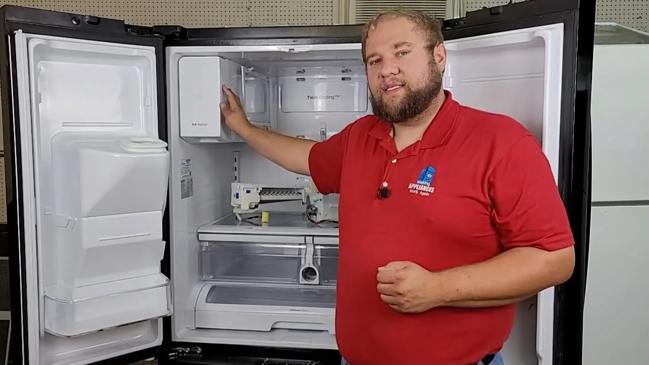 A person reads a manual while troubleshooting a refrigerator in a modern kitchen.